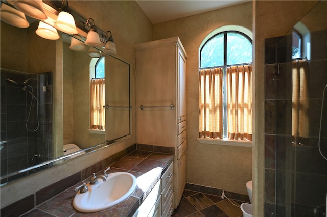 full bath featuring toilet, a shower with door, tile patterned floors, and vanity