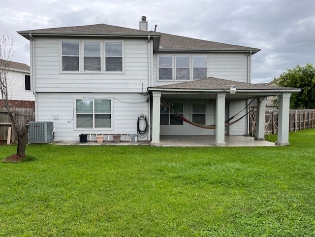 back of property with central AC, a yard, a patio, and fence