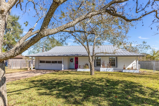 single story home with driveway, metal roof, an attached garage, fence, and a front yard