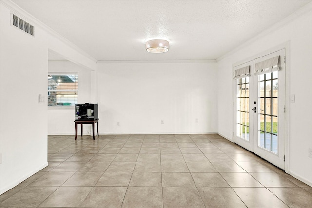 empty room with ornamental molding, french doors, visible vents, and plenty of natural light