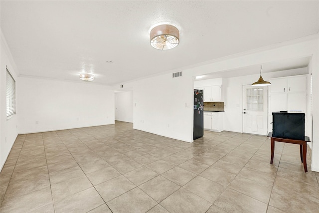 unfurnished living room featuring light tile patterned flooring, visible vents, and crown molding