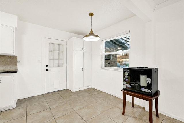 dining room with light tile patterned floors and baseboards