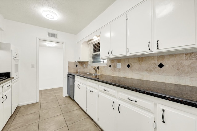 kitchen with white cabinetry, a sink, and dishwasher