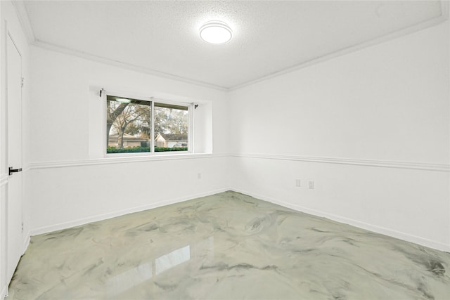 empty room with baseboards, a textured ceiling, ornamental molding, and concrete flooring