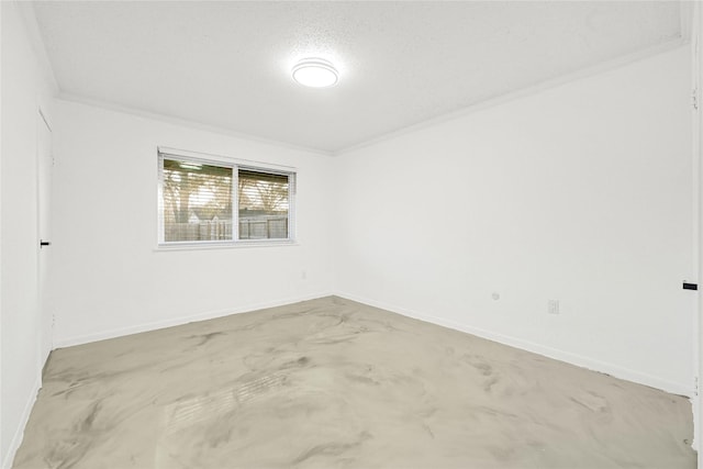 unfurnished room with concrete floors, baseboards, and ornamental molding