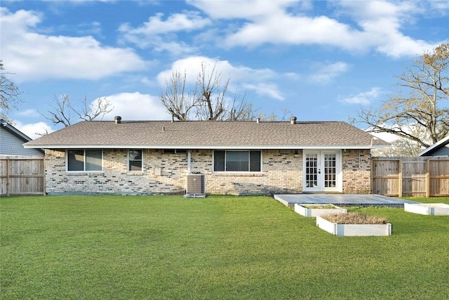 back of property featuring central AC unit, a yard, fence, and french doors