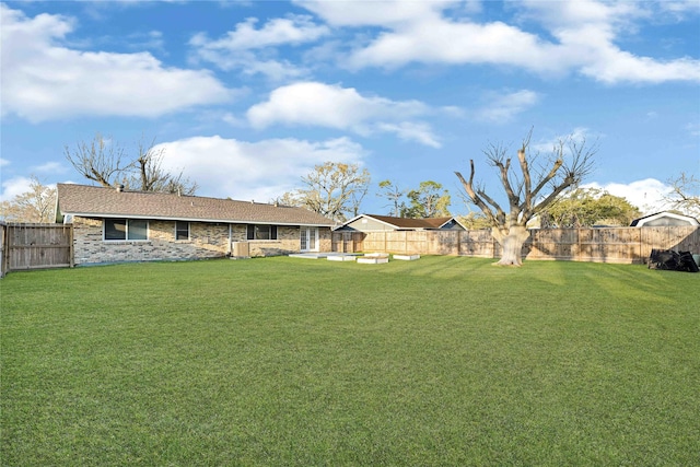 view of yard with a fenced backyard