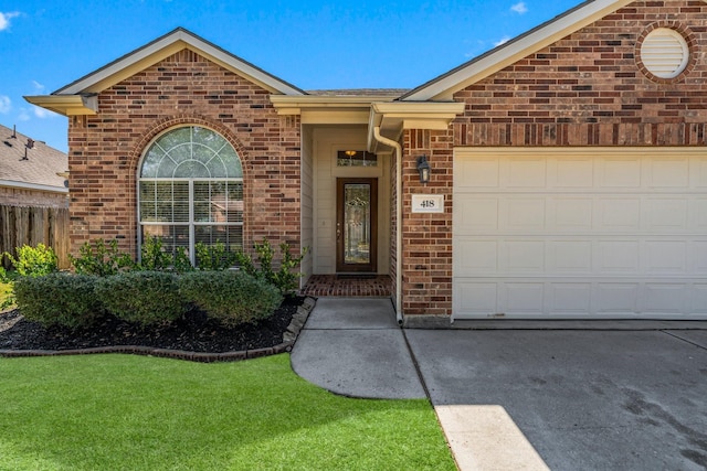 property entrance with brick siding, an attached garage, and fence