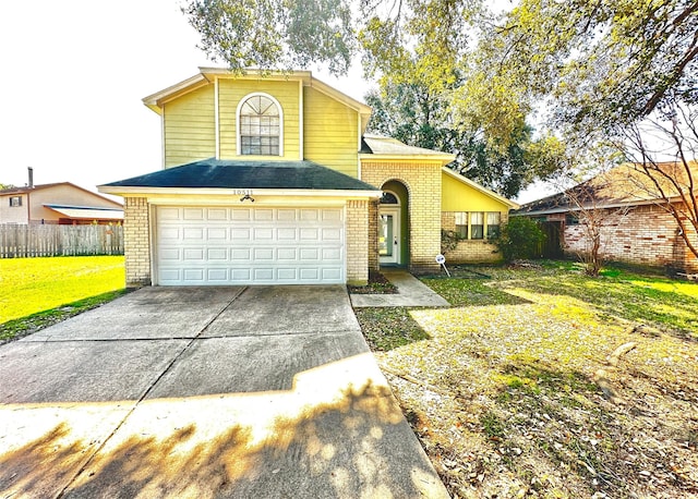 traditional home with brick siding, fence, a garage, driveway, and a front lawn