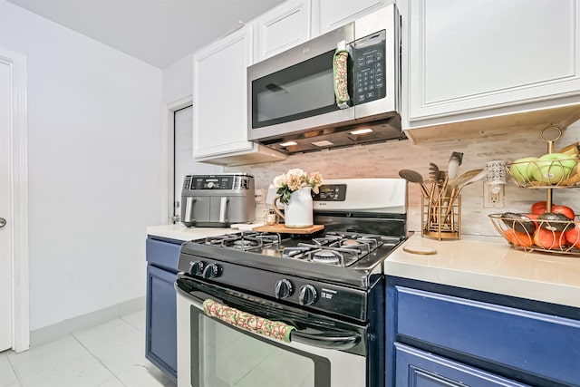 kitchen with stainless steel appliances, backsplash, white cabinets, and blue cabinets