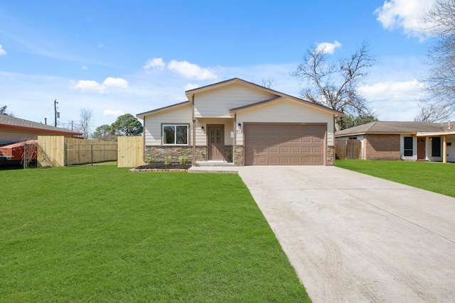 view of front facade featuring a garage, concrete driveway, stone siding, fence, and a front lawn