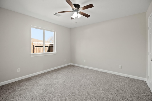 unfurnished room with carpet floors, baseboards, visible vents, and ceiling fan