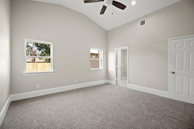 carpeted spare room with a ceiling fan, baseboards, visible vents, and a wealth of natural light