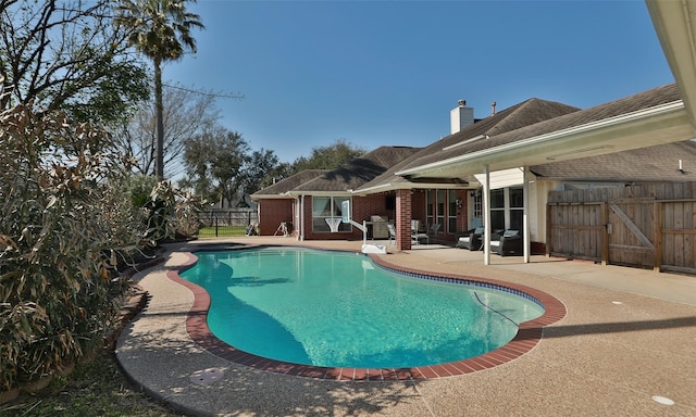 view of pool featuring a patio area, a grill, fence, and a fenced in pool