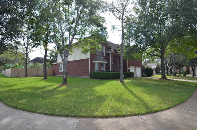 view of side of home with a yard, fence, and brick siding