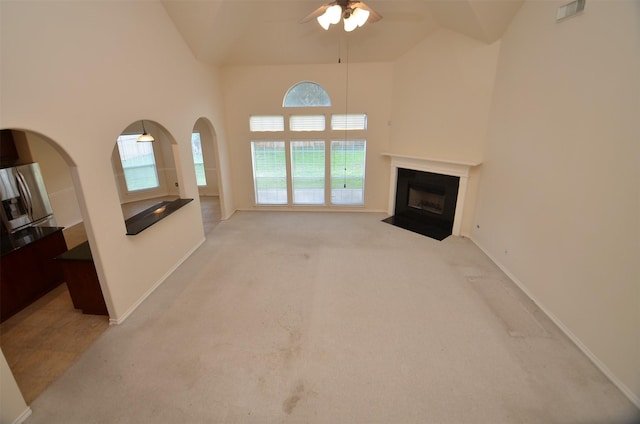 living area featuring a fireplace with flush hearth, light colored carpet, visible vents, and baseboards