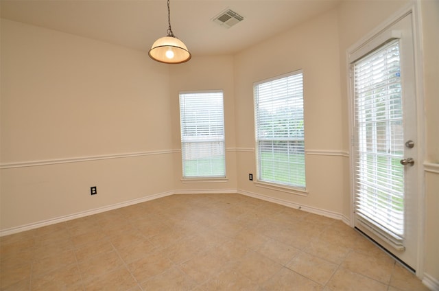 spare room with visible vents and baseboards