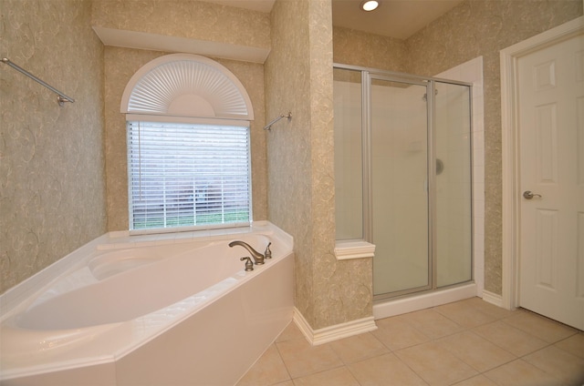 full bathroom with wallpapered walls, a bath, a shower stall, and tile patterned flooring