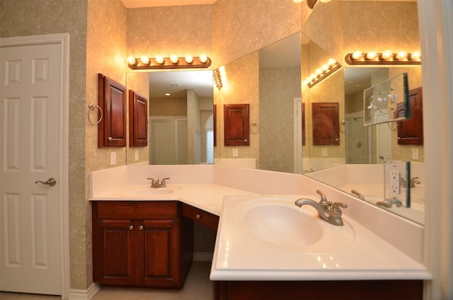 bathroom featuring a shower stall, double vanity, tile patterned floors, and a sink