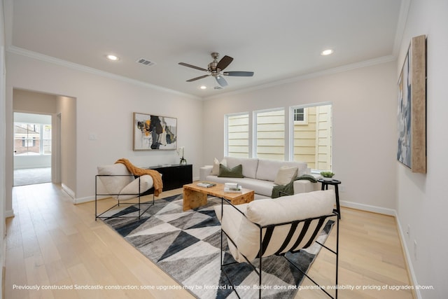 living room with recessed lighting, visible vents, baseboards, ornamental molding, and light wood finished floors