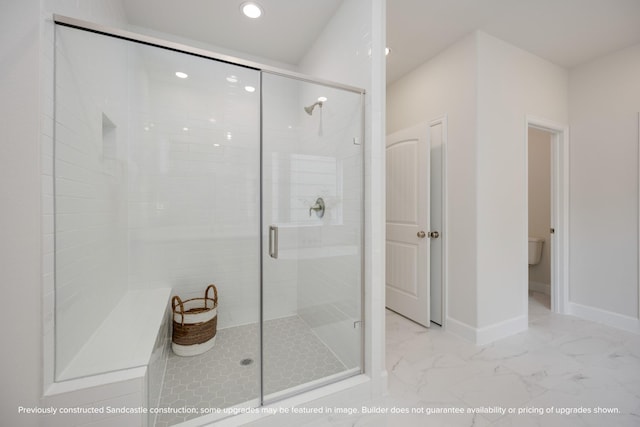 full bathroom with toilet, marble finish floor, a shower stall, and baseboards