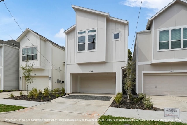 contemporary home featuring board and batten siding, concrete driveway, and an attached garage