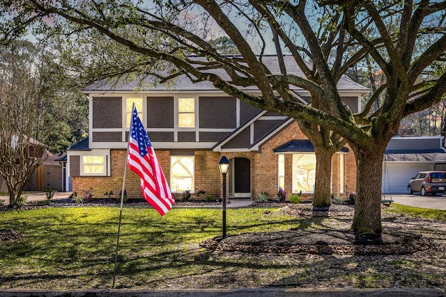 view of front of house with a front yard and brick siding