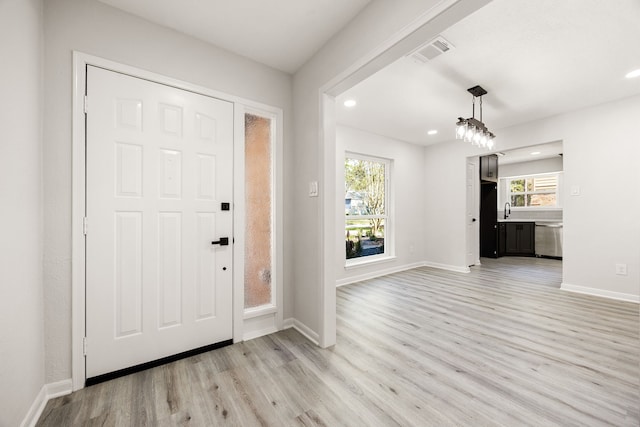 foyer entrance featuring light wood-style flooring, visible vents, baseboards, and recessed lighting