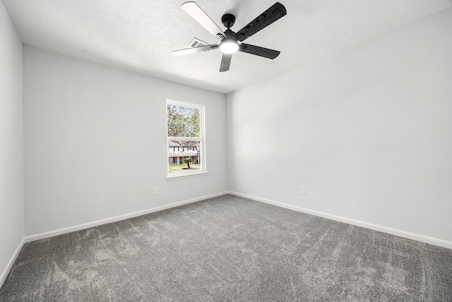 carpeted empty room featuring a ceiling fan, a textured ceiling, and baseboards