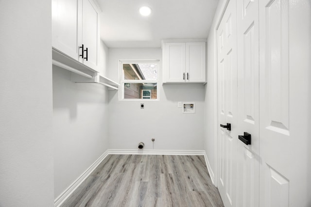 washroom featuring light wood-style flooring, washer hookup, baseboards, cabinet space, and electric dryer hookup