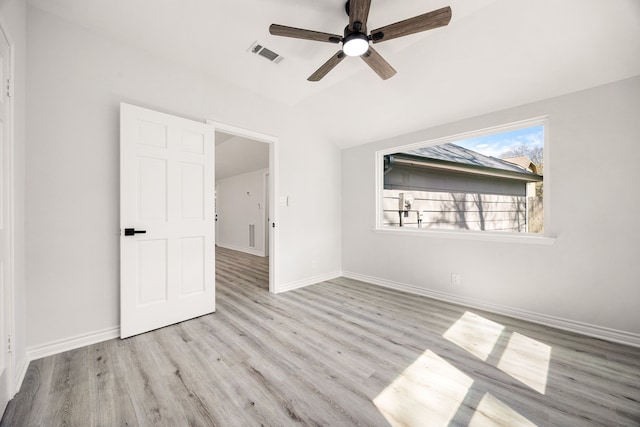 unfurnished bedroom with a ceiling fan, wood finished floors, visible vents, and baseboards