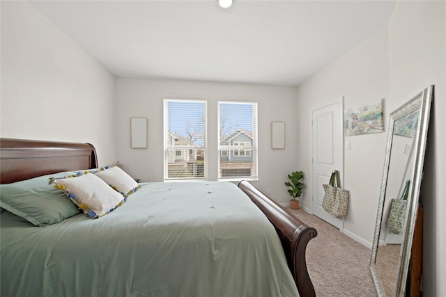 bedroom with carpet flooring and baseboards