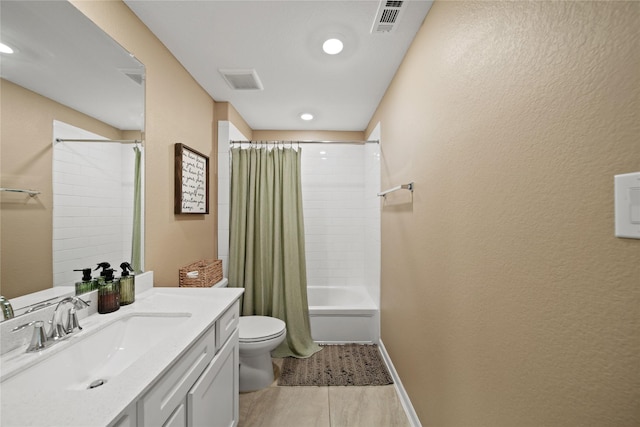 full bath with toilet, visible vents, vanity, baseboards, and shower / bath combination with curtain