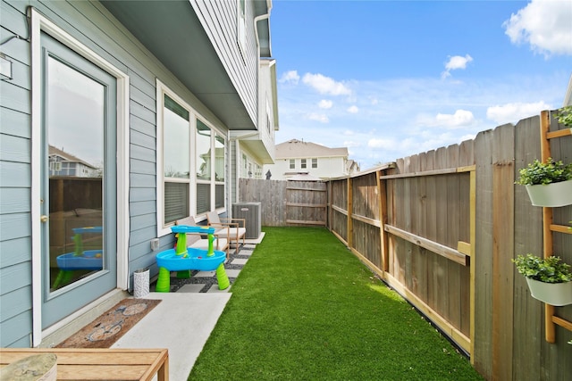 view of yard with a fenced backyard and cooling unit