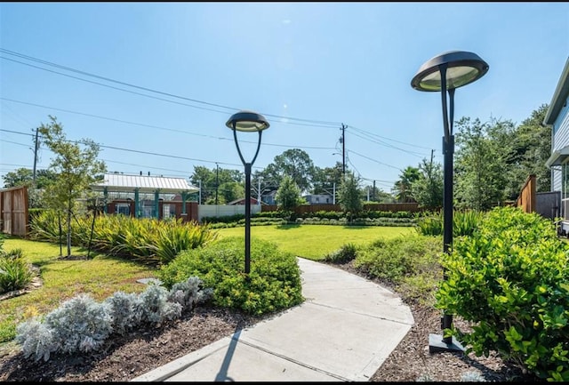 surrounding community with a yard and fence