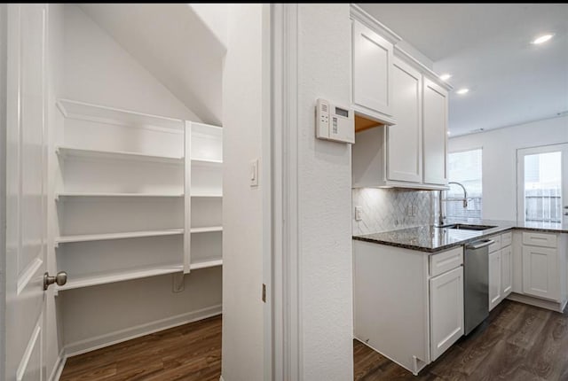 kitchen with dark wood finished floors, a sink, and dishwasher