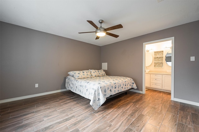 bedroom with a ceiling fan, ensuite bath, baseboards, and wood finished floors