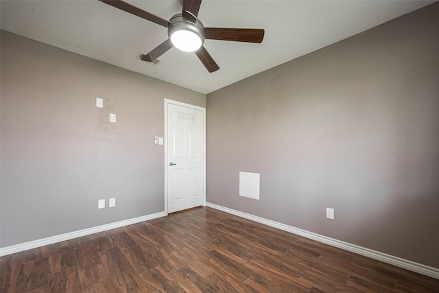 spare room featuring a ceiling fan, visible vents, baseboards, and dark wood-type flooring