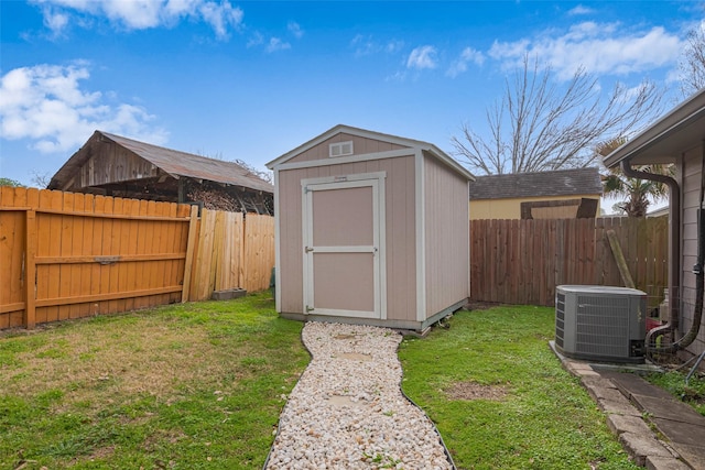 view of shed featuring cooling unit and a fenced backyard