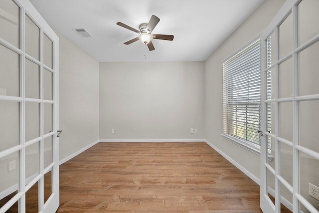 empty room featuring visible vents, french doors, and light wood-style flooring