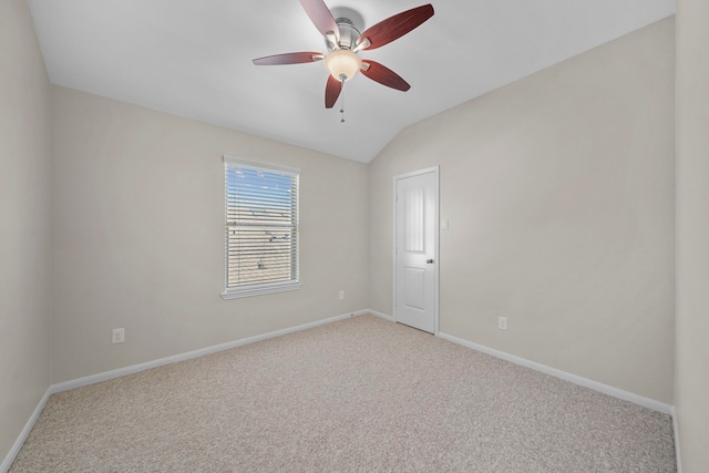 unfurnished room featuring light carpet, lofted ceiling, a ceiling fan, and baseboards