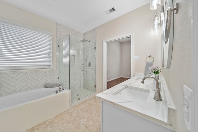 bathroom with visible vents, tile patterned floors, vanity, a shower stall, and a bath