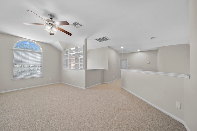 spare room with attic access, carpet, visible vents, and baseboards