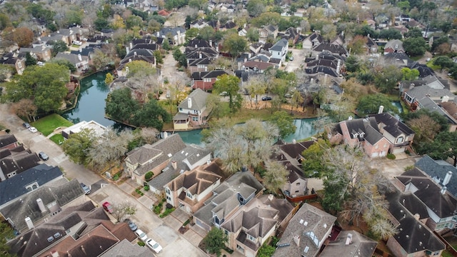 birds eye view of property with a water view and a residential view