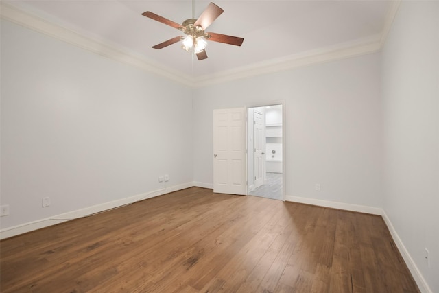 unfurnished room with a ceiling fan, wood-type flooring, baseboards, and crown molding