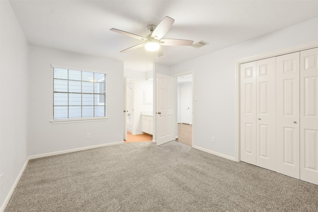 unfurnished bedroom featuring visible vents, baseboards, a ceiling fan, carpet, and a closet