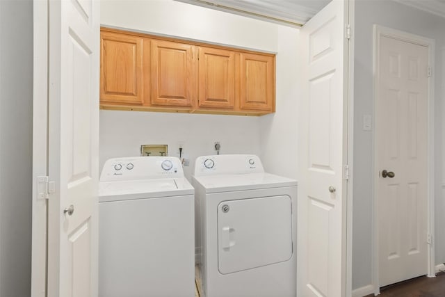 clothes washing area featuring cabinet space and washing machine and dryer