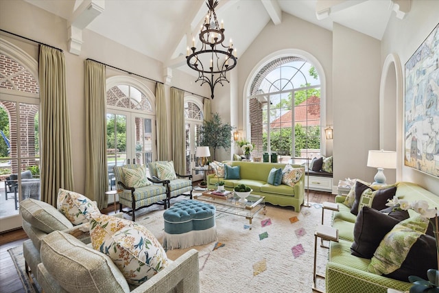 interior space with lofted ceiling with beams, french doors, plenty of natural light, and an inviting chandelier