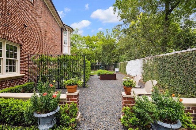 view of yard with fence and a vegetable garden