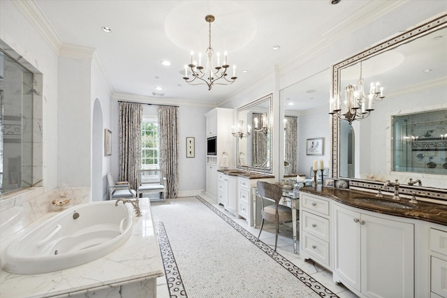 bathroom with ornamental molding, a sink, a chandelier, a jetted tub, and baseboards